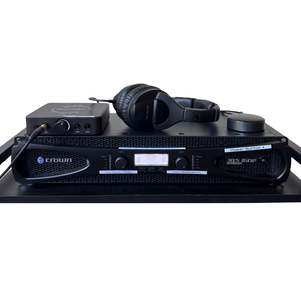Crown XLS 1502 amplifier with audio interface and headphones for sound therapy and vibroacoustic sessions.