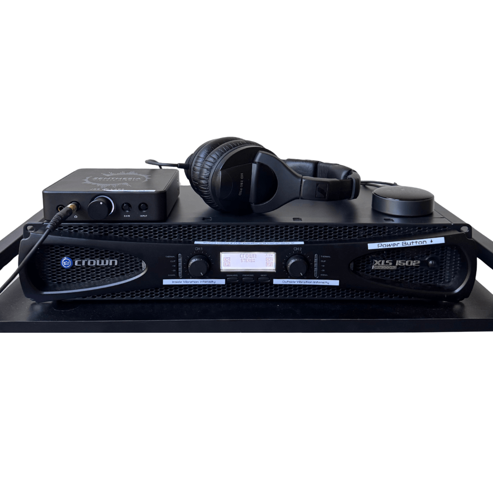 Crown XLS 1502 amplifier with audio interface and headphones for sound therapy and vibroacoustic sessions.